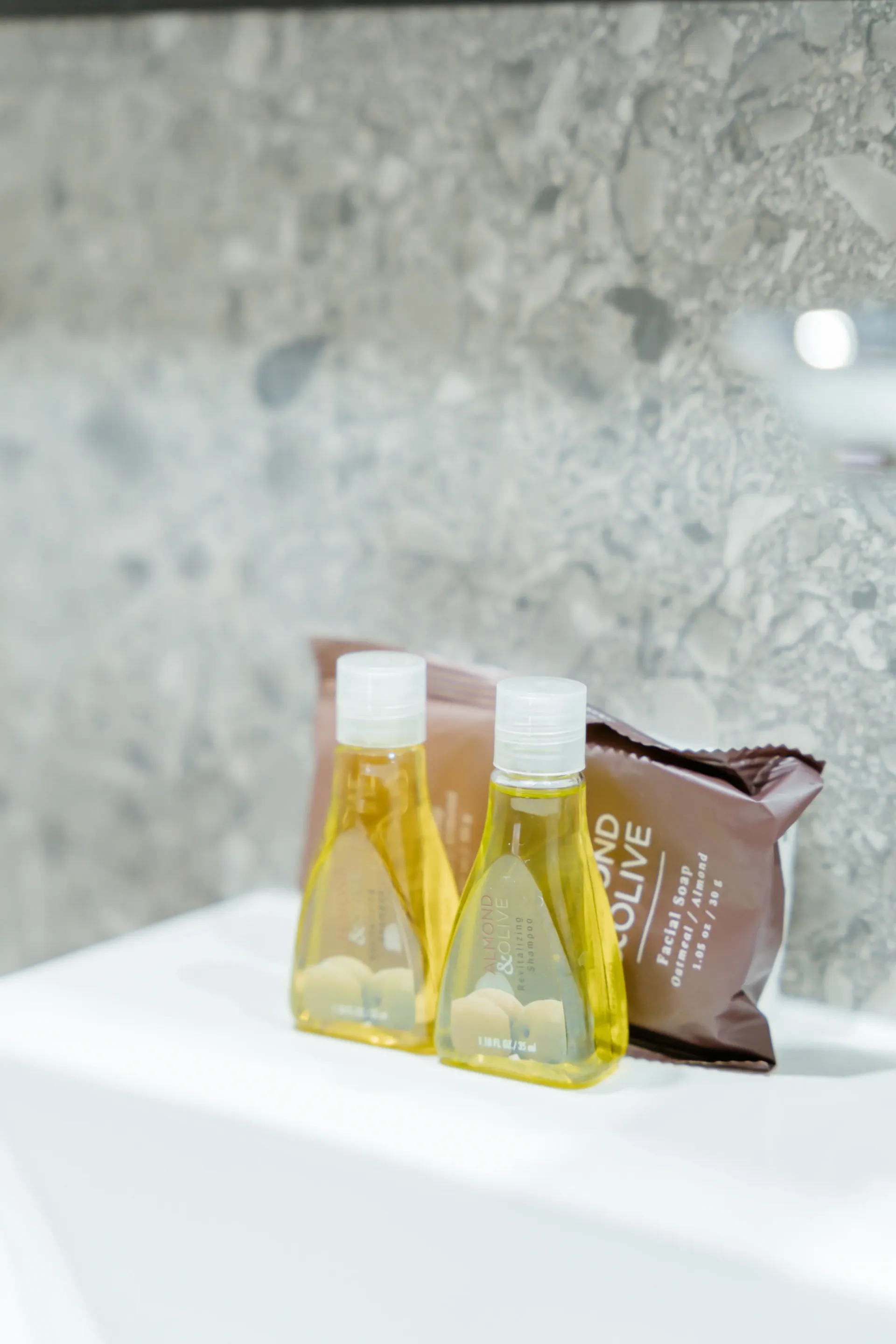 A bathroom sink with bottles of soap and lotion on it.