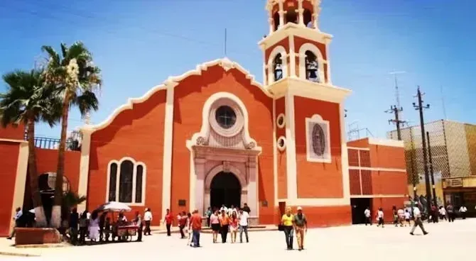 A group of people are standing in front of a church