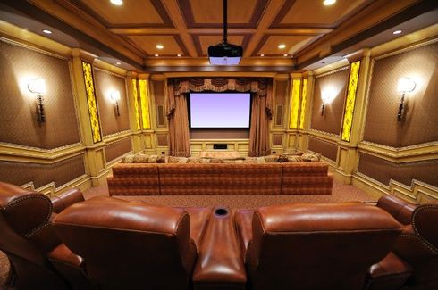 a home theater with a projector and a large screen