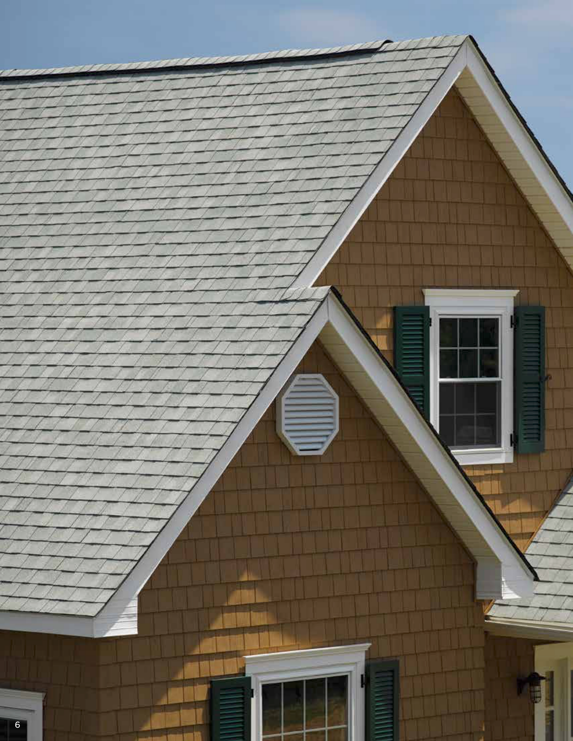 A house with a white roof and green shutters