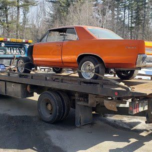 Classic car being towed by Mark's towing and Transport of Buxton Maine