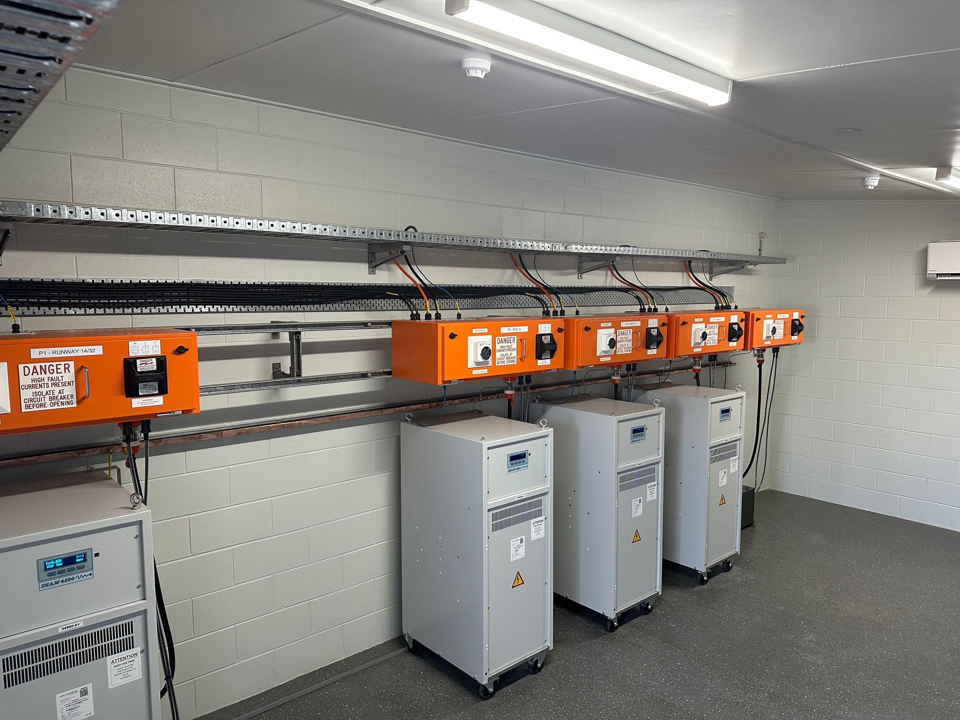 Runway at sunset with glowing lights, mountains in the distance and a colorful sky.