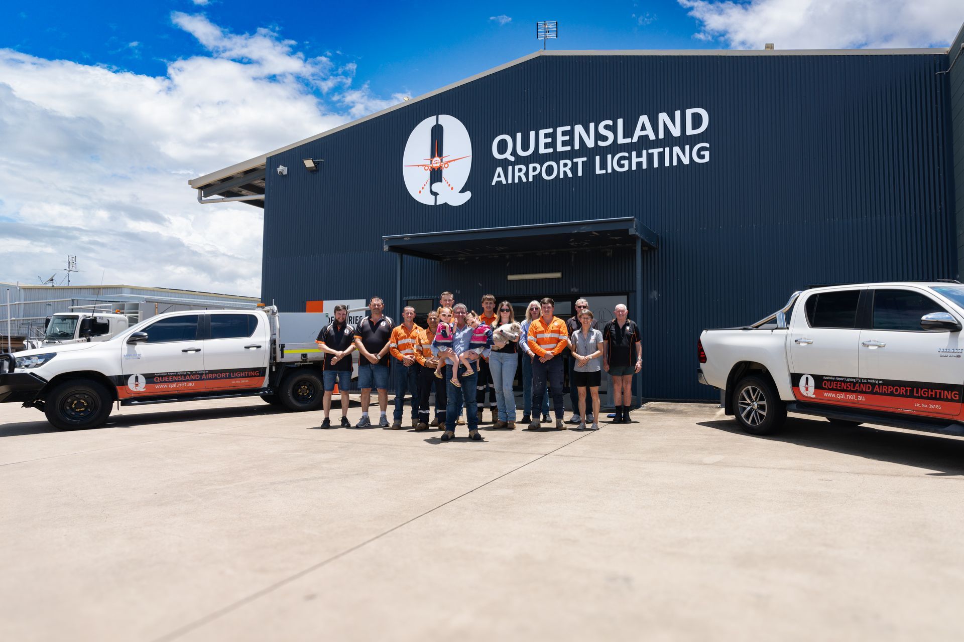 Airplane landing on illuminated runway at dusk.