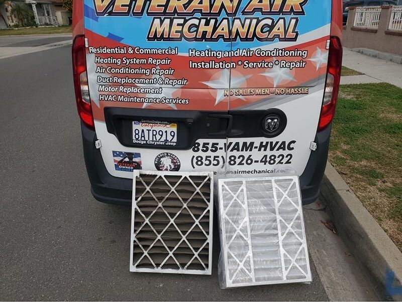 Dirty and new air filters next to a Veteran Air Mechanical van.