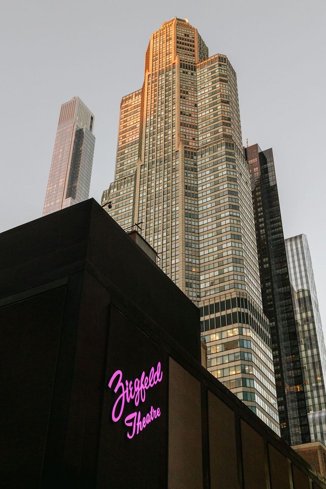 A tall building with a theater below.