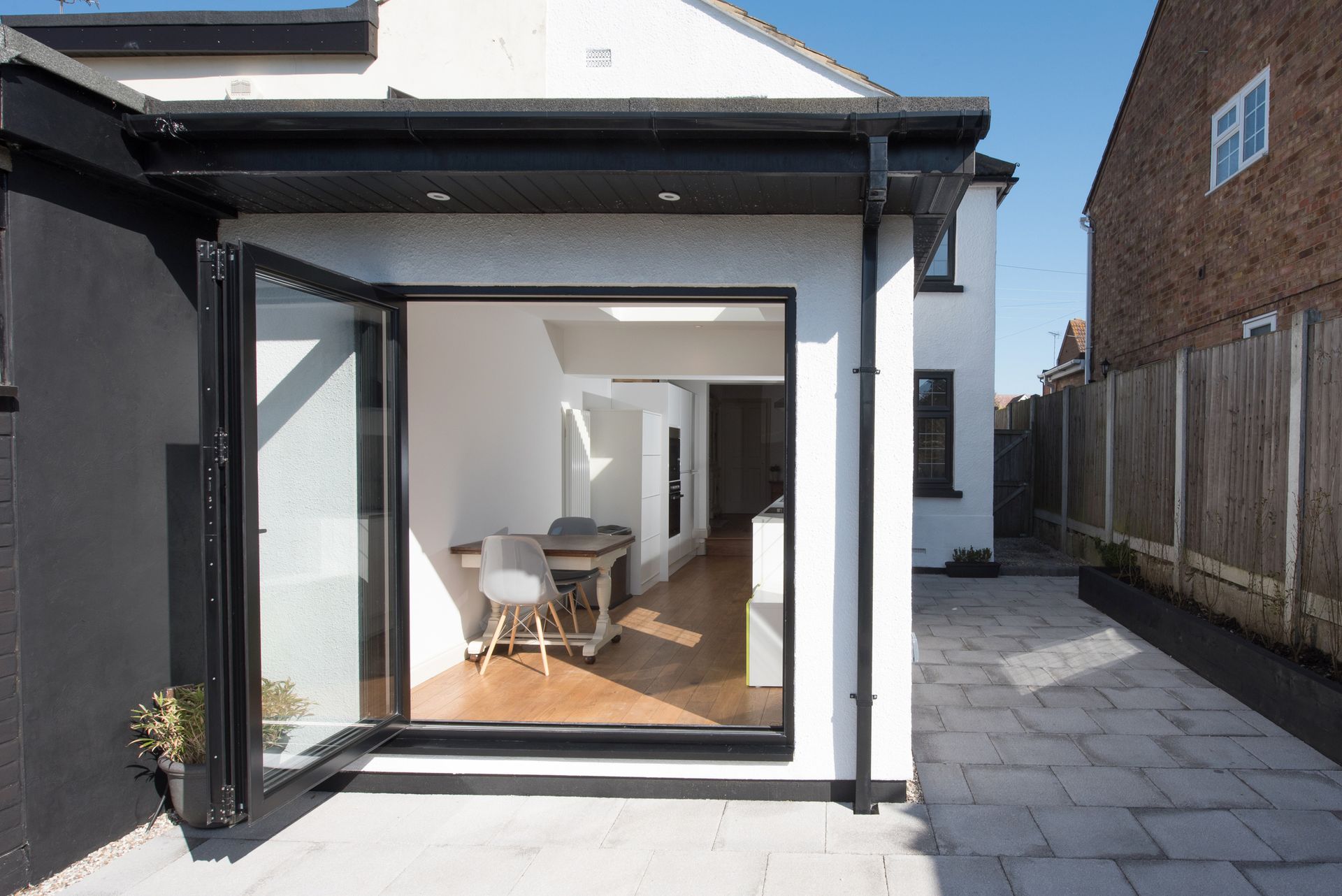 A house with a large sliding glass door leading to a patio - Douglassville, PA - Integrity Home Remodel