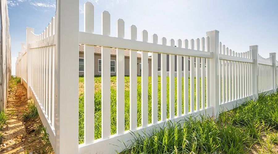 White vinyl picket fence installed with sturdy posts