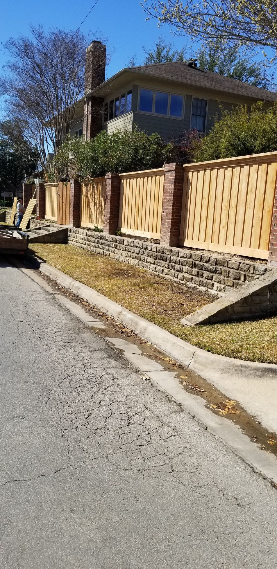 Board on board wood fence with brick columns