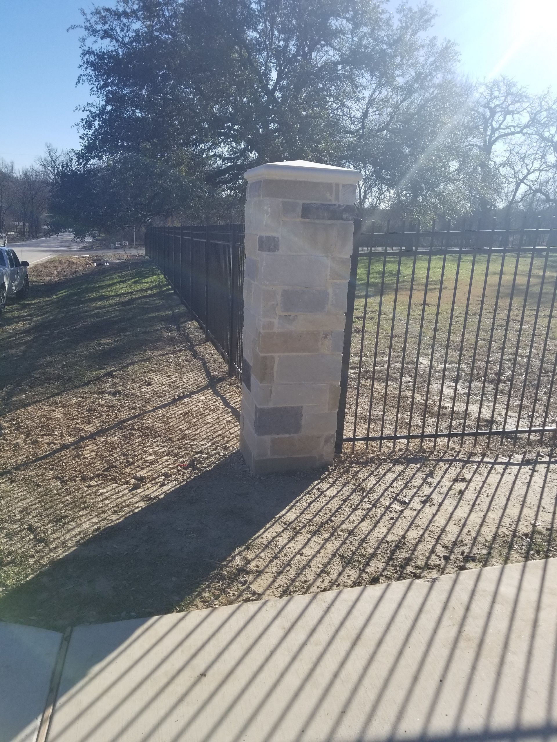 Stone columns with metal fencing
