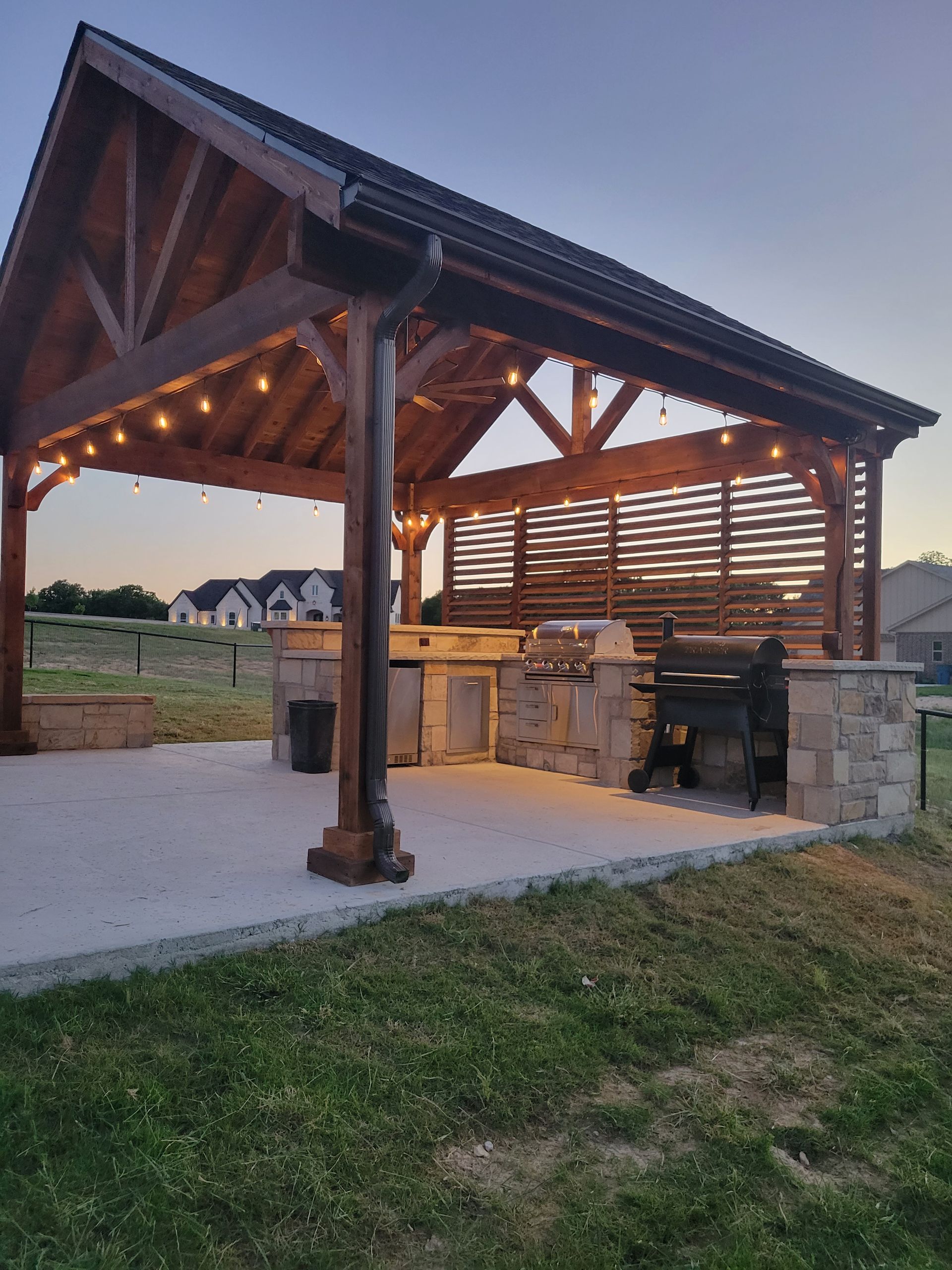 Outdoor Living space with a patio structure and outdoor stone kitchen