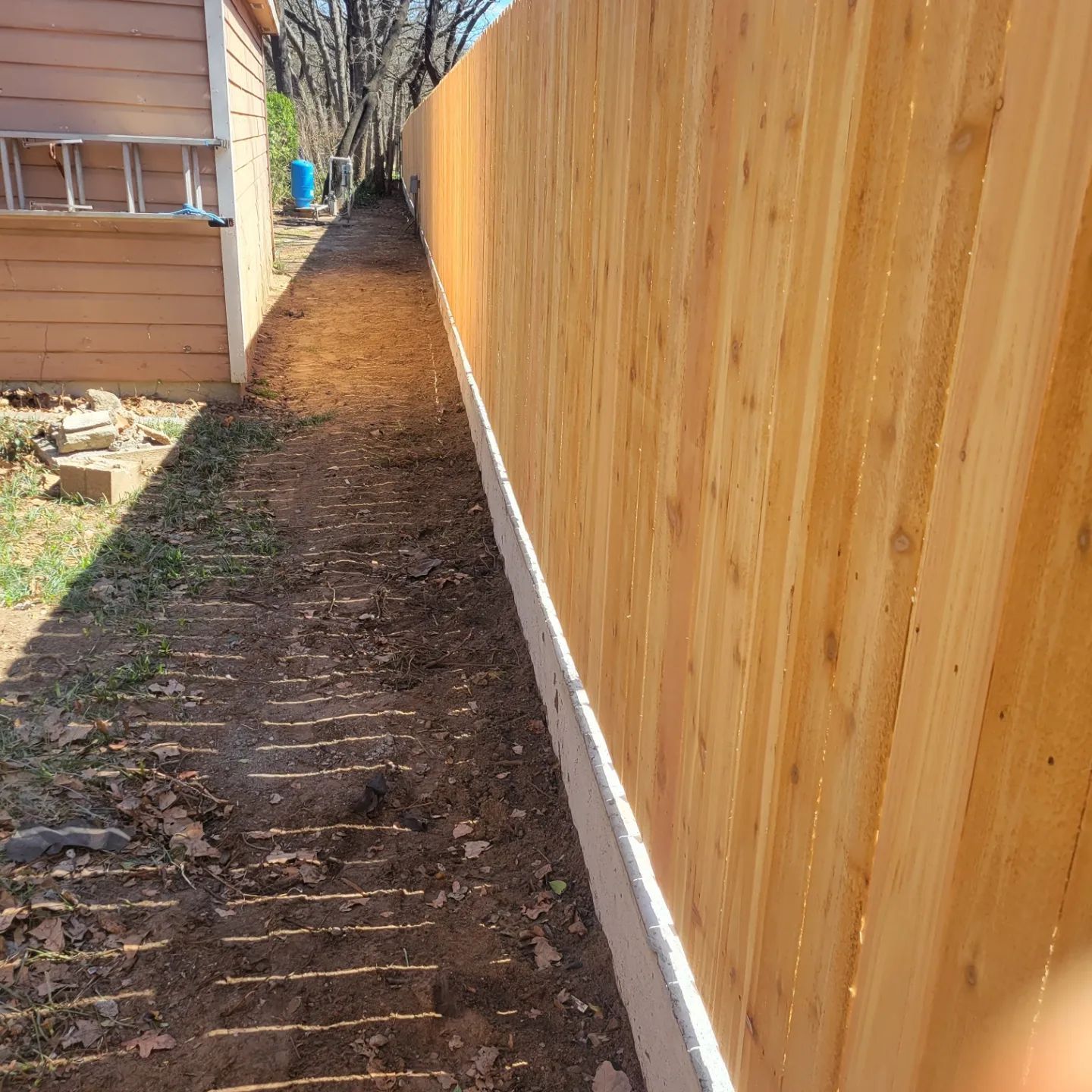 Cedar wood fence with concrete retaining wall