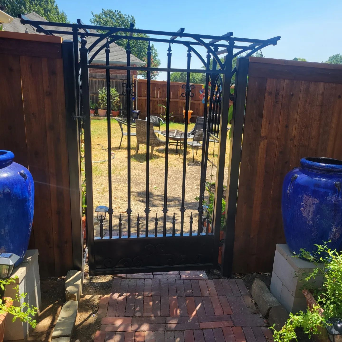 Custom arched iron pedestrian gate