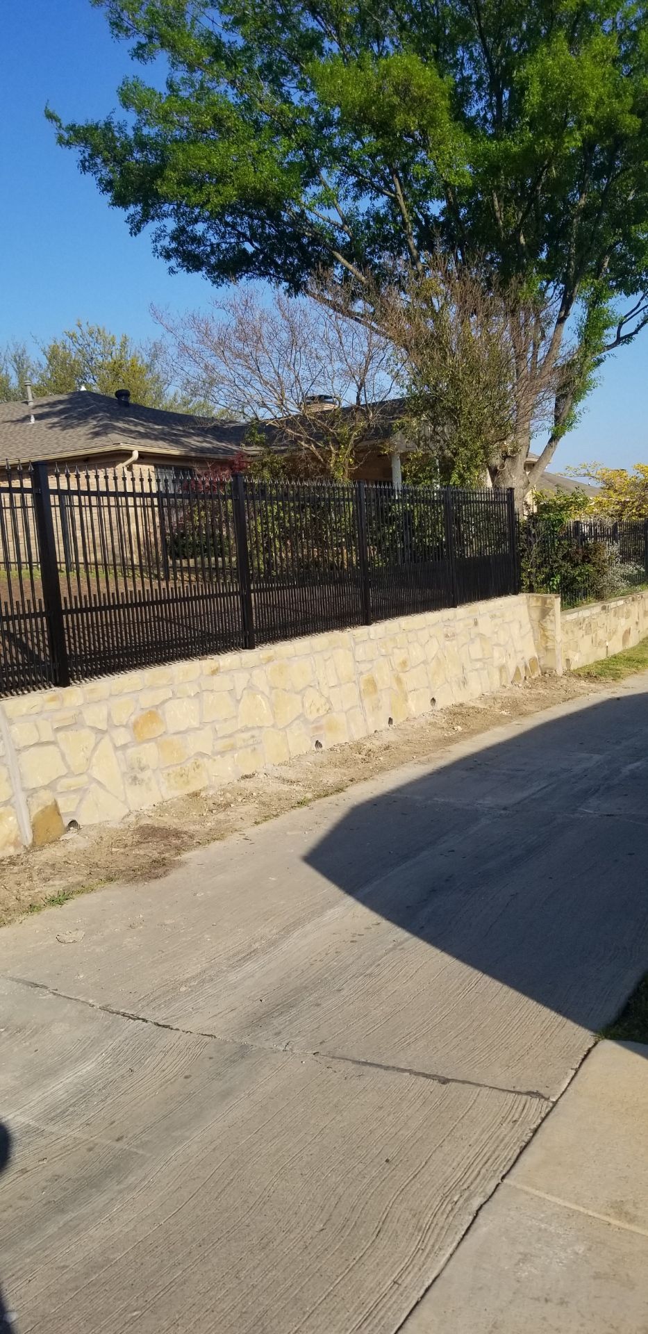 Stone wall and iron fencing