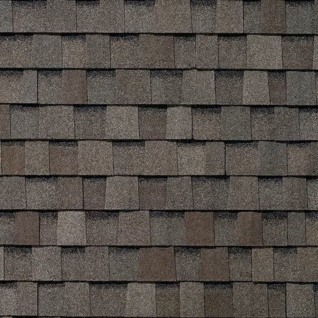 Close-up of brown asphalt roof shingles in a staggered pattern.
