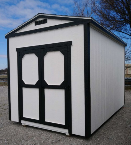 White storage shed with black trim and double doors; outdoor setting.