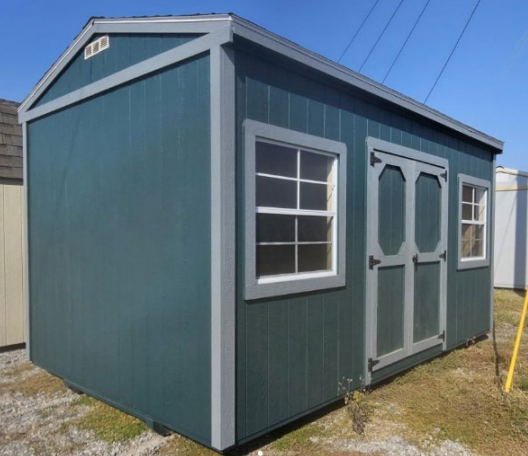 Blue shed with white-framed windows and doors, grey trim, and a sloped roof.