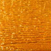 Close-up of golden-brown wood grain with horizontal lines and scattered light spots.