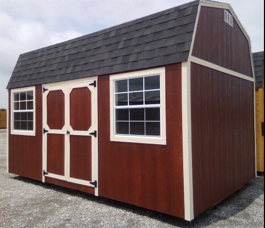 Red barn-style shed with white trim, black roof, and two windows and doors, set outside.