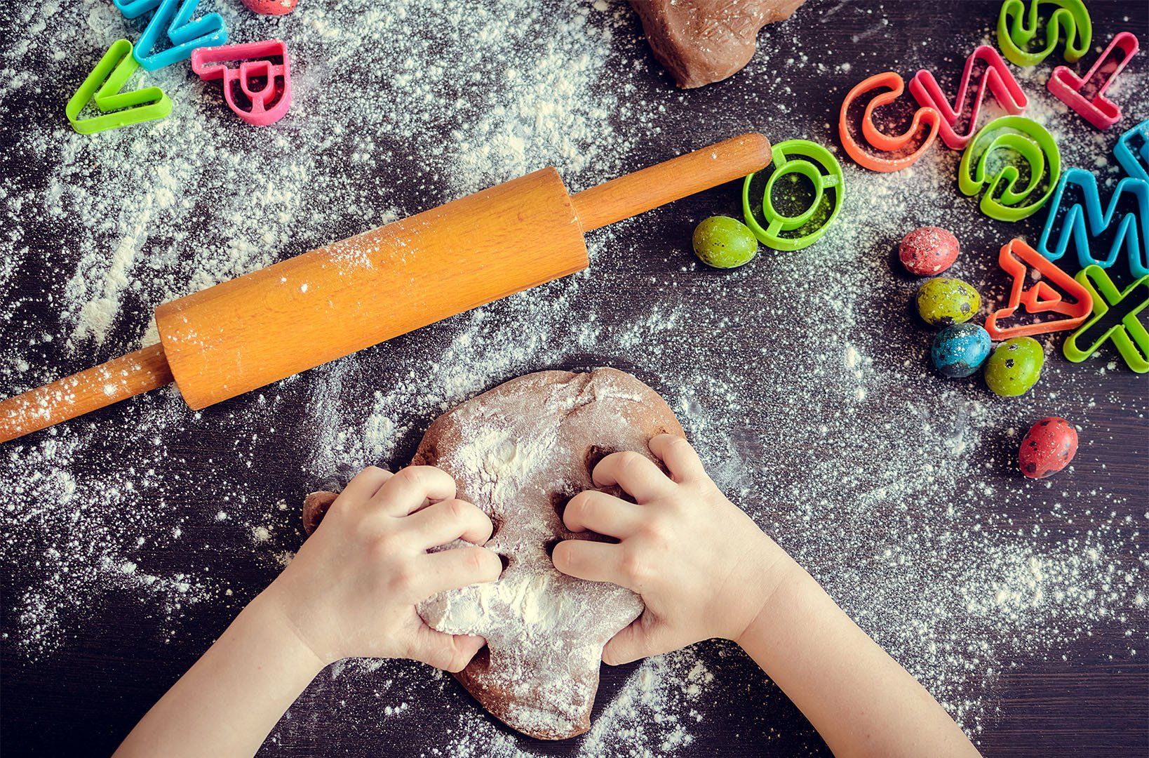 little child's hand kneading dough