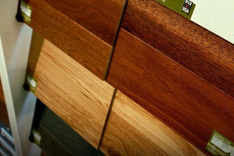 Wooden flooring samples in different brown tones displayed side by side.