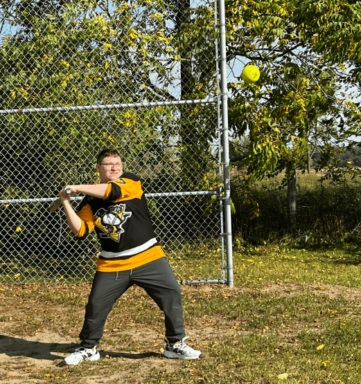 A resident playing baseball