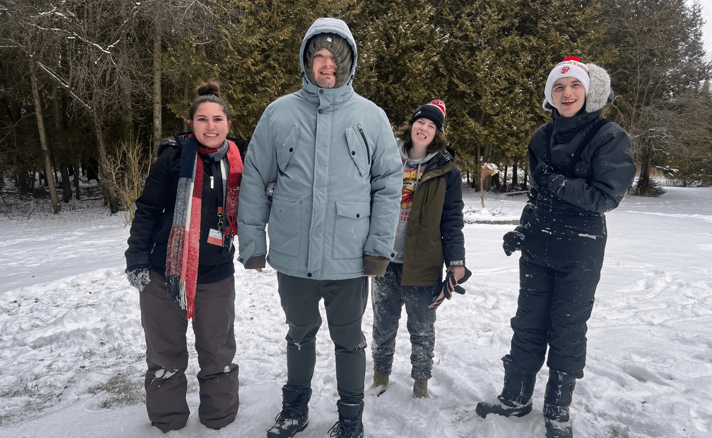 A group of people are standing in the snow.