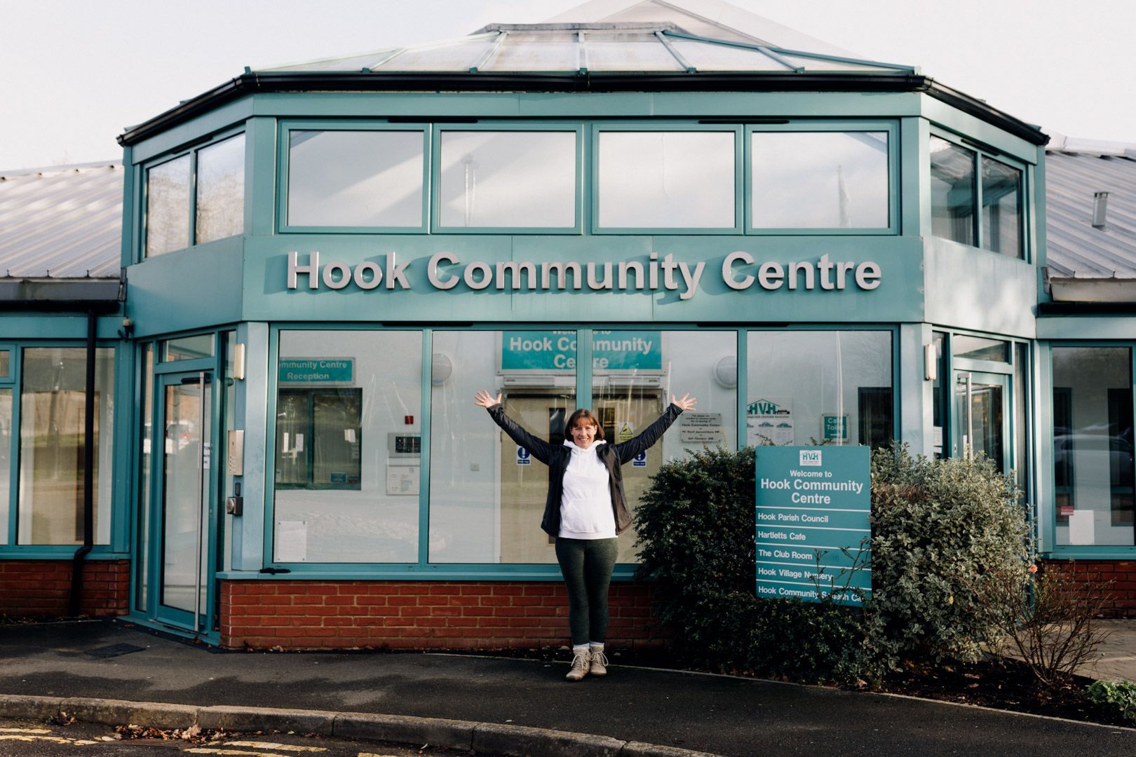 photo of Pilates instructor outside Hook Community Centre with her arms raised above her head