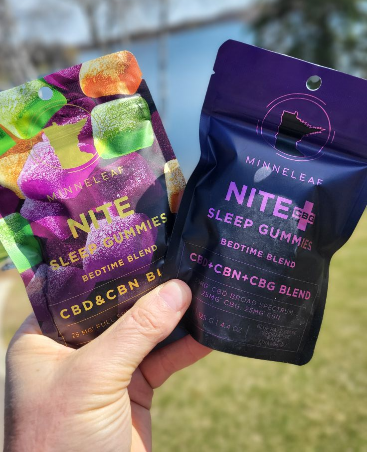 A person is holding two bags of nite sleep gummies in their hand.
