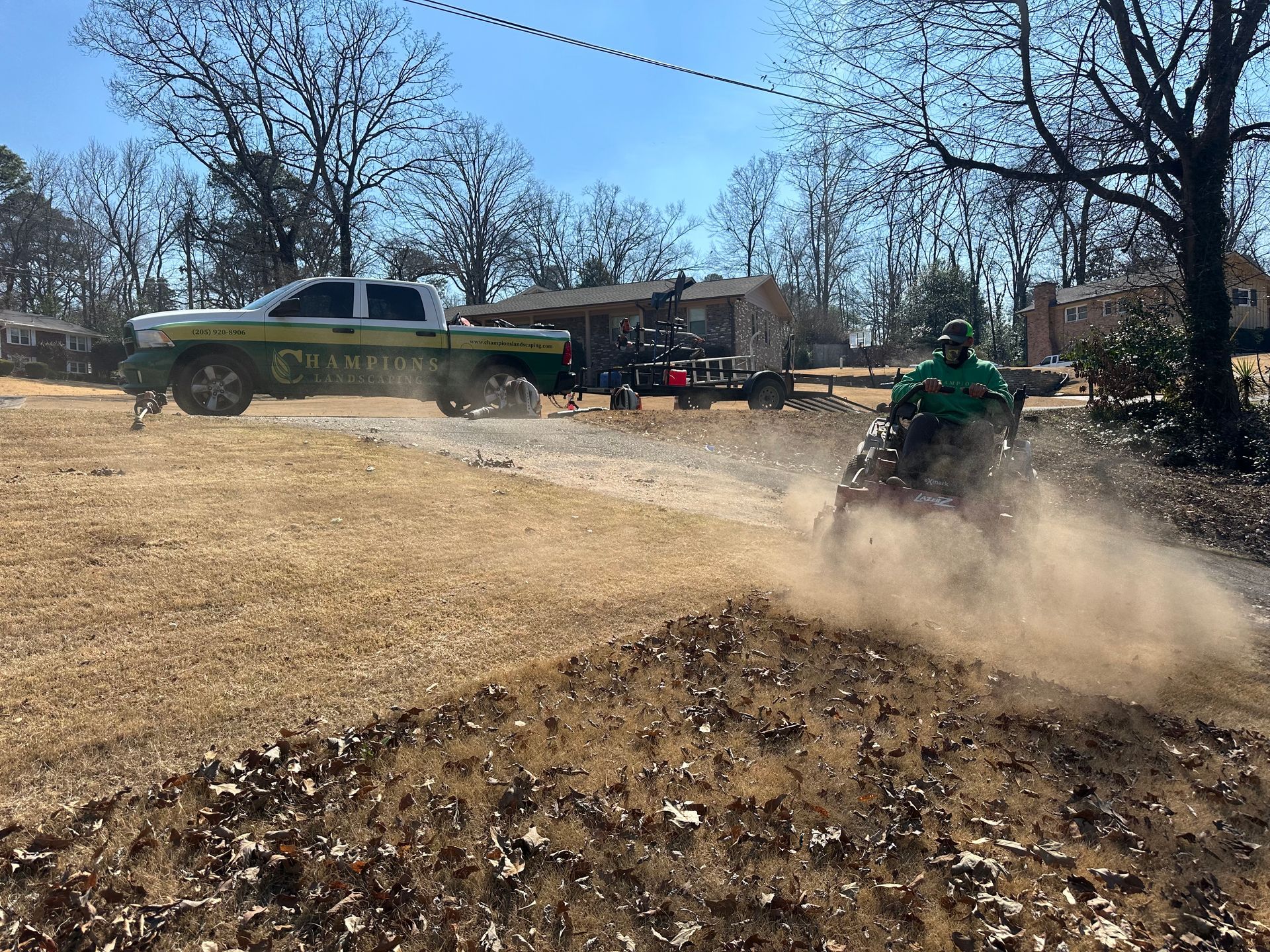a man is riding a dirt bike on a dirt road next to a truck .