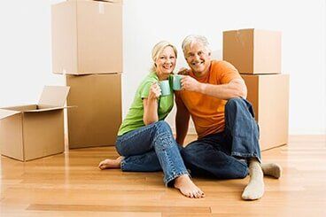 Man and woman with moving boxes — Moving Company in Altoona, PA