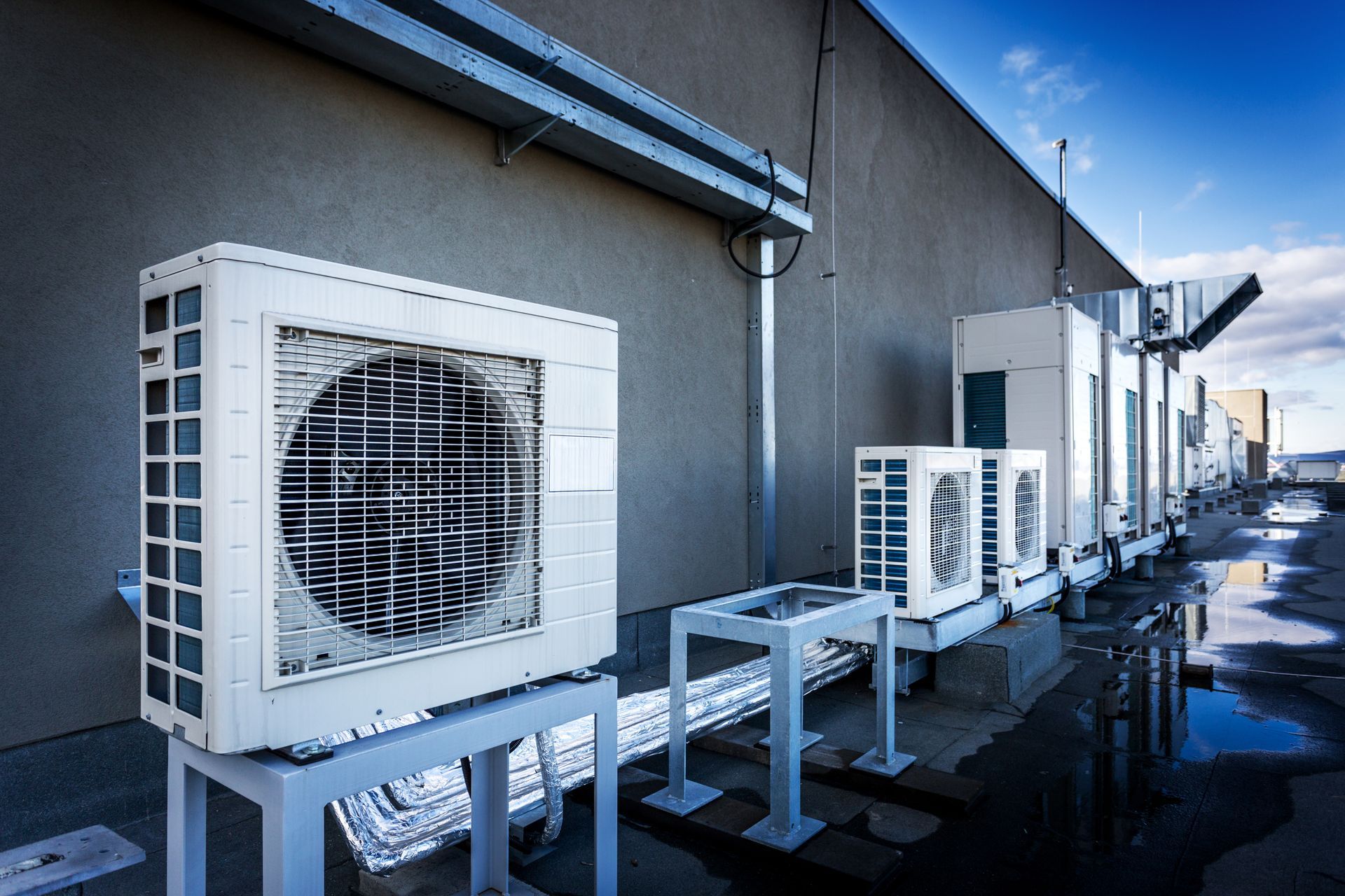 Commercial HVAC rooftop units installed outside a building by a commercial air conditioning contractor. Commercial HVAC rooftop units installed outside a building by a commercial air conditioning contractor.