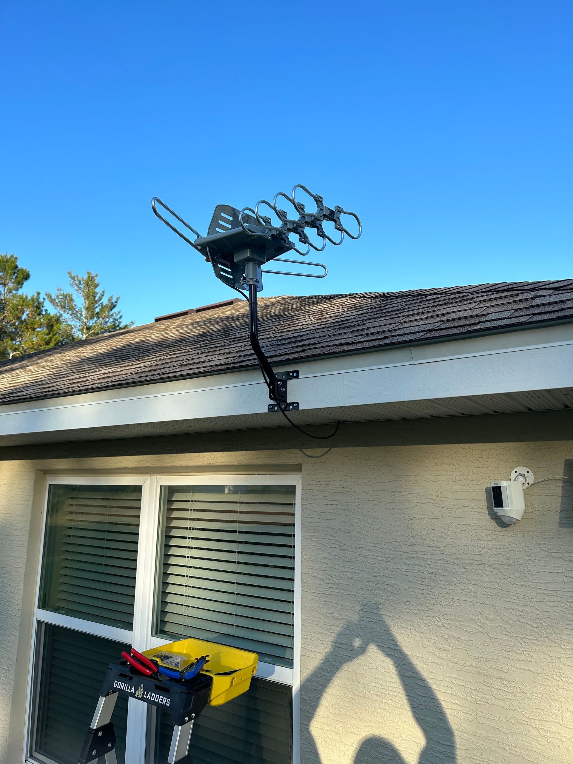 An antenna is mounted on the roof of a house.