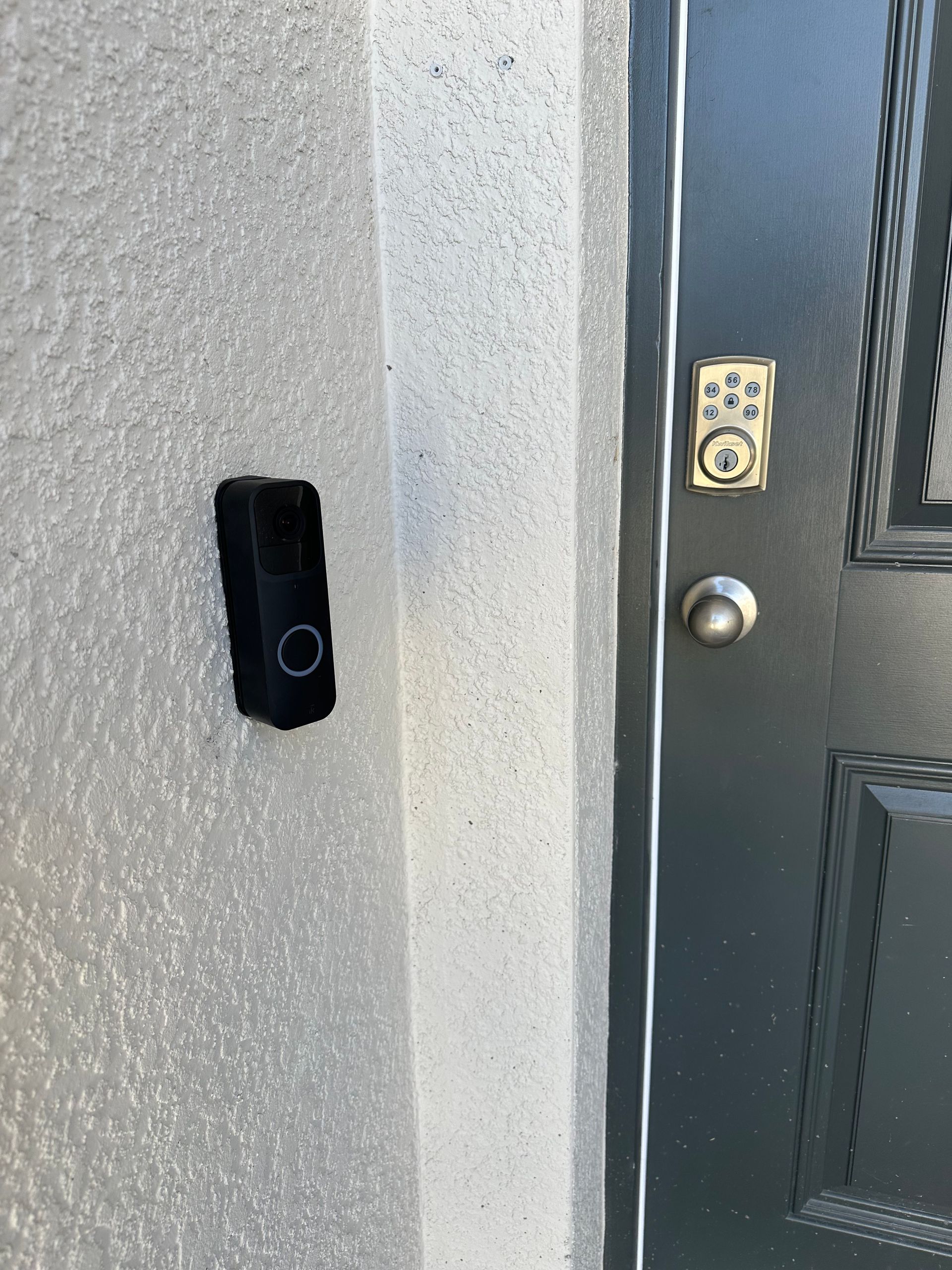 A doorbell is attached to the side of a door.