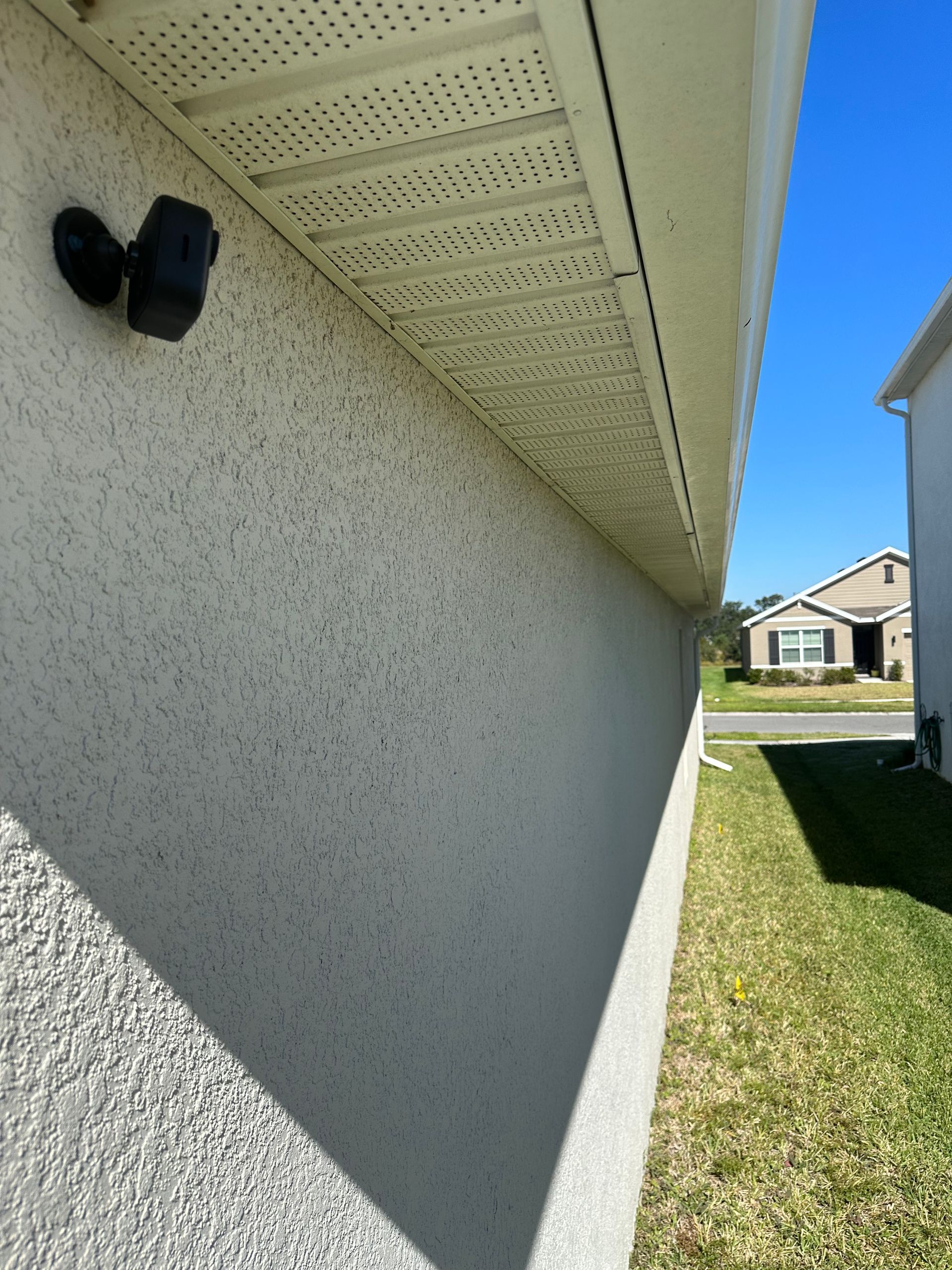 A white house with a black light on the side of it