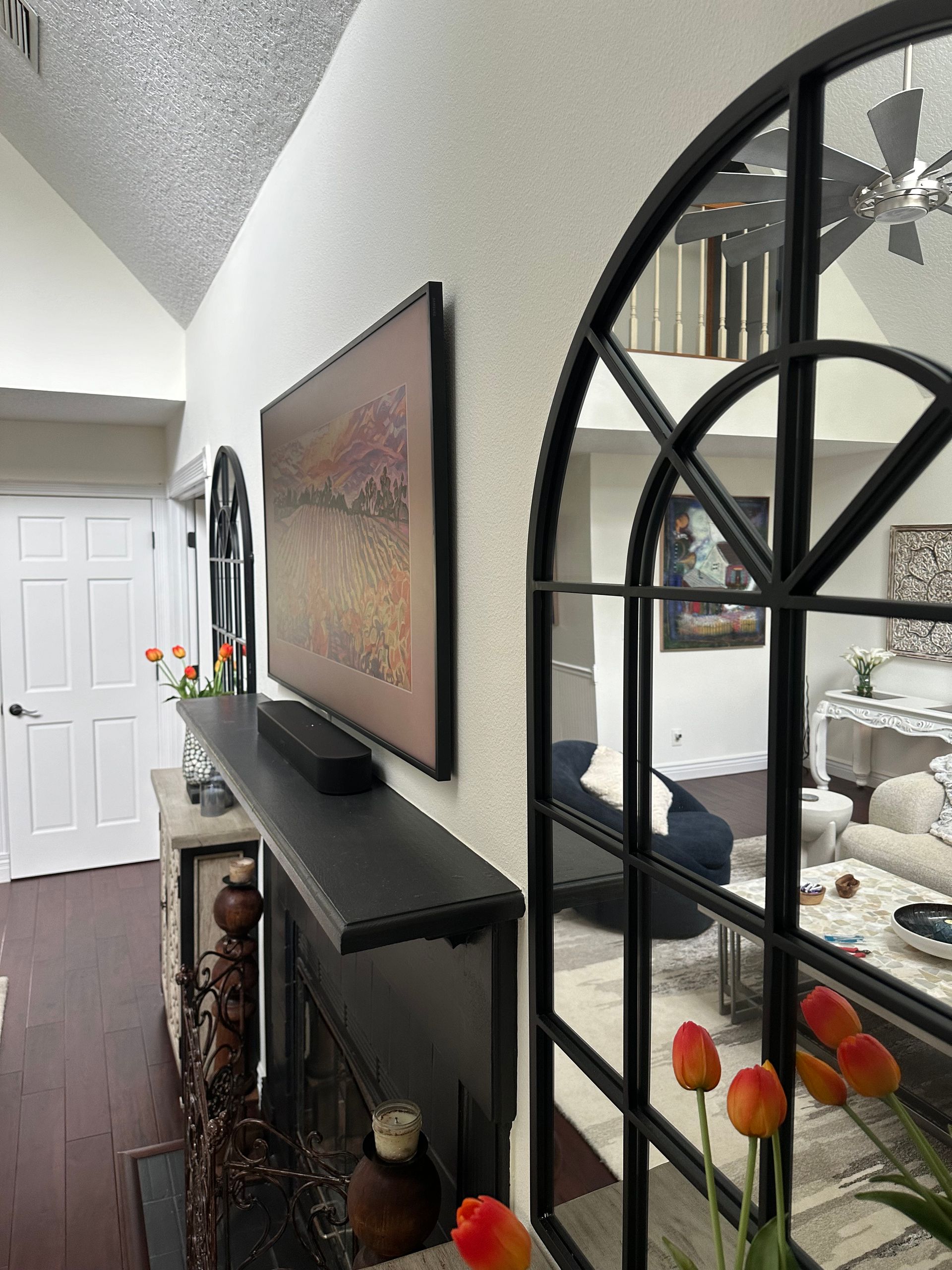 A living room with a fireplace and a large mirror