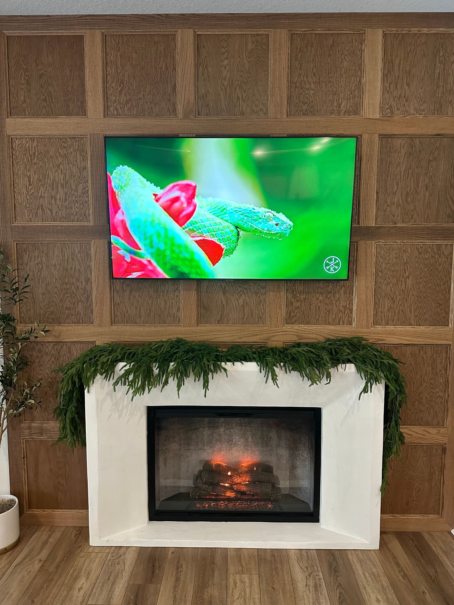 A living room with a fireplace and a flat screen tv above it.