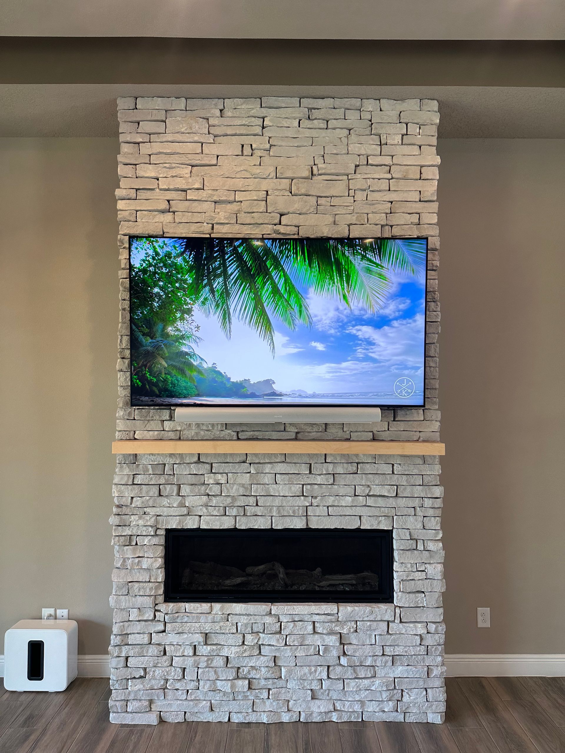 A brick fireplace with a flat screen tv above it