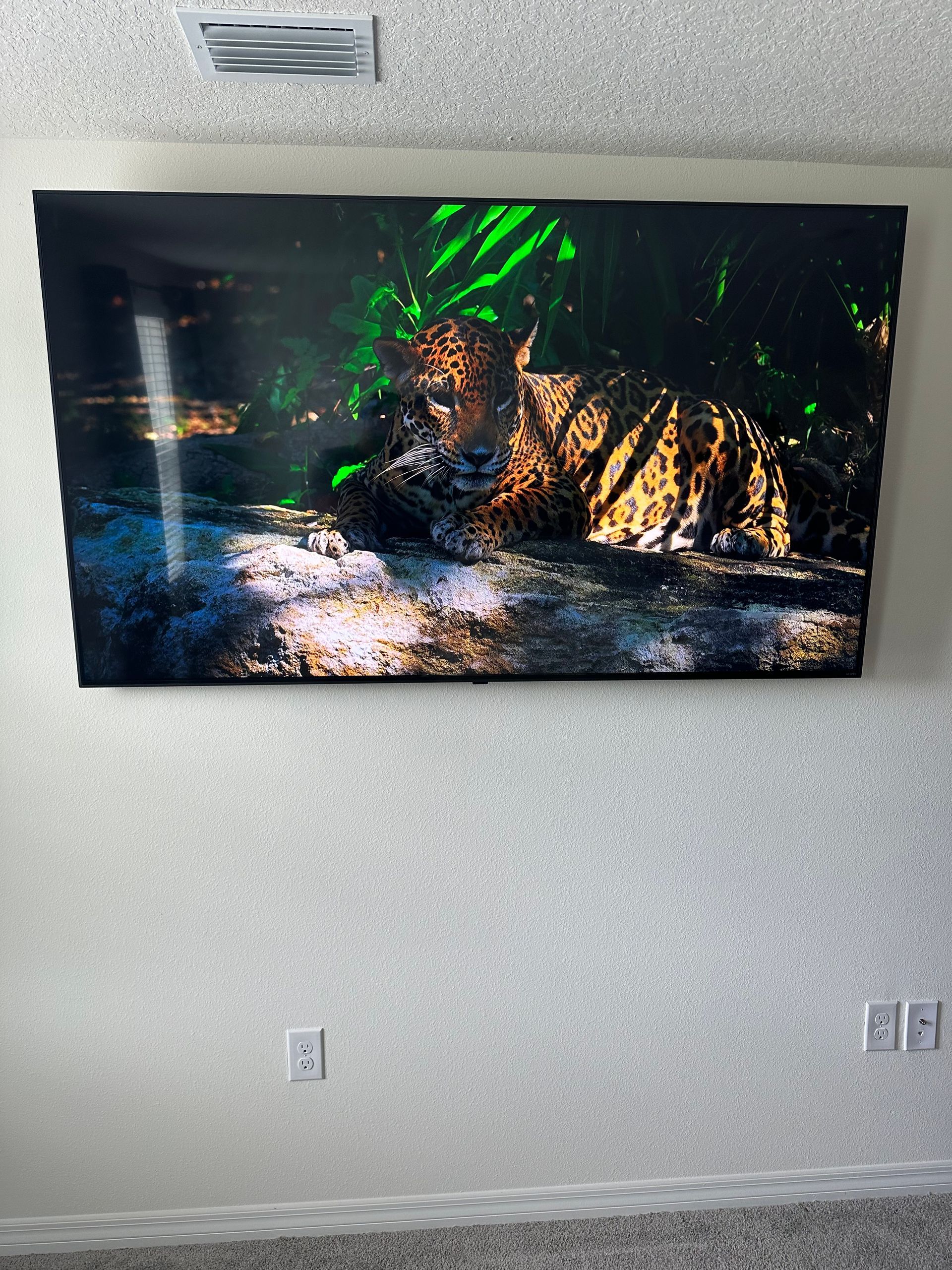 A large painting of a leopard is hanging on a wall.