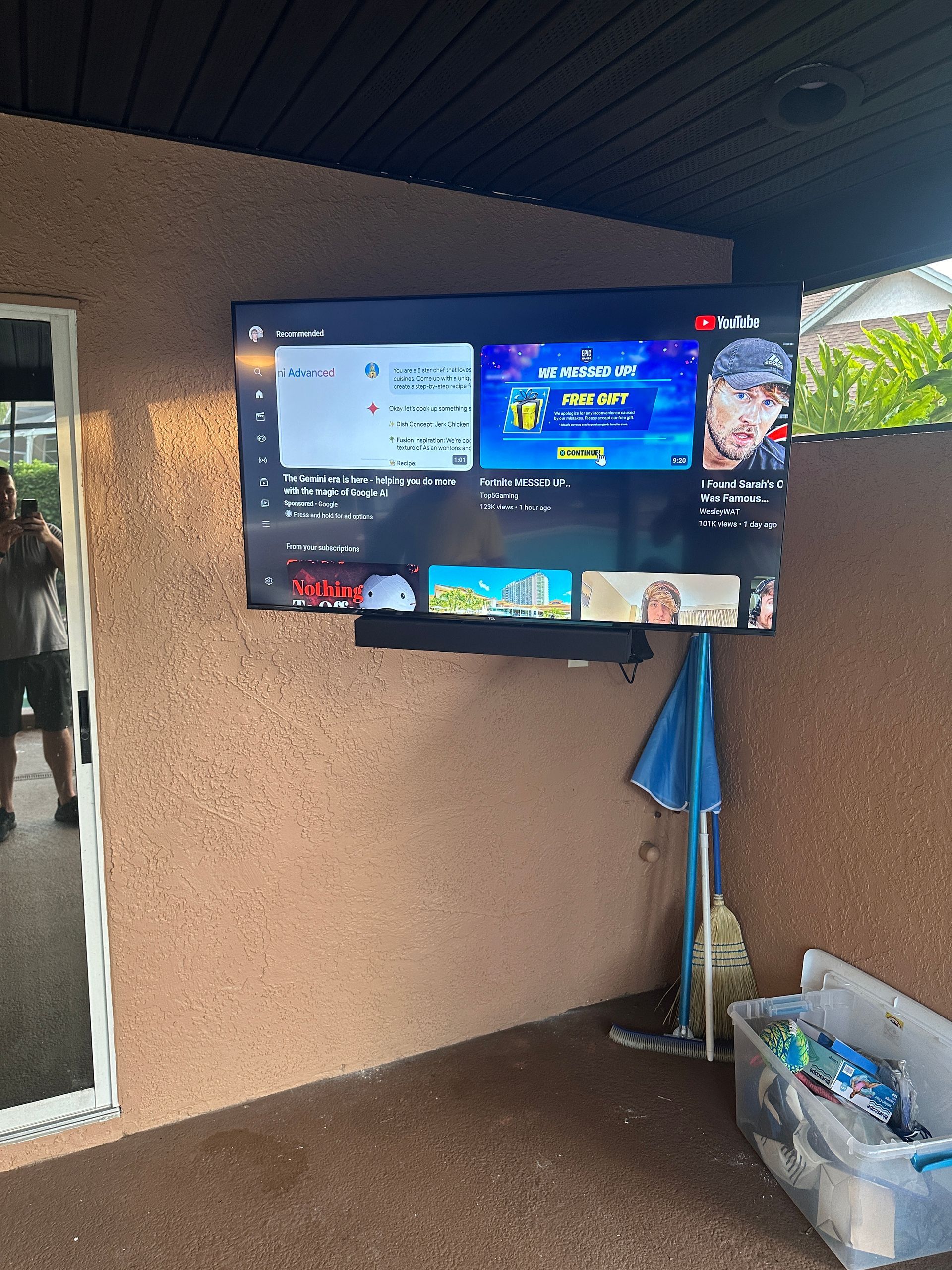 A large flat screen tv is mounted on a wall