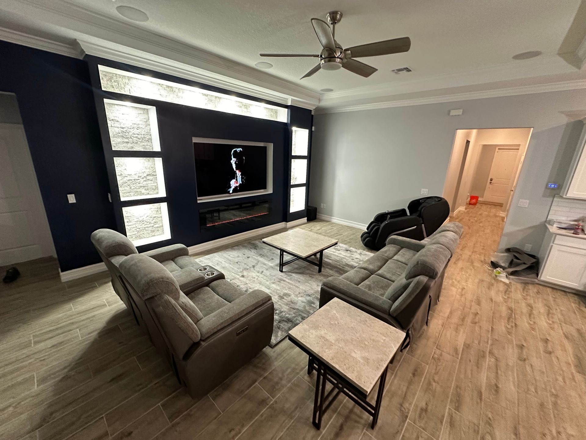 A living room with a couch , chair , coffee table , and television.