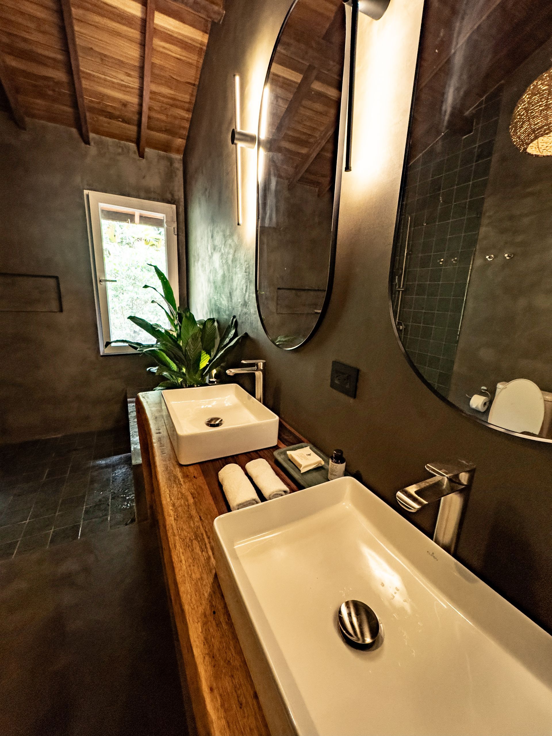 A bathroom with two sinks and two mirrors