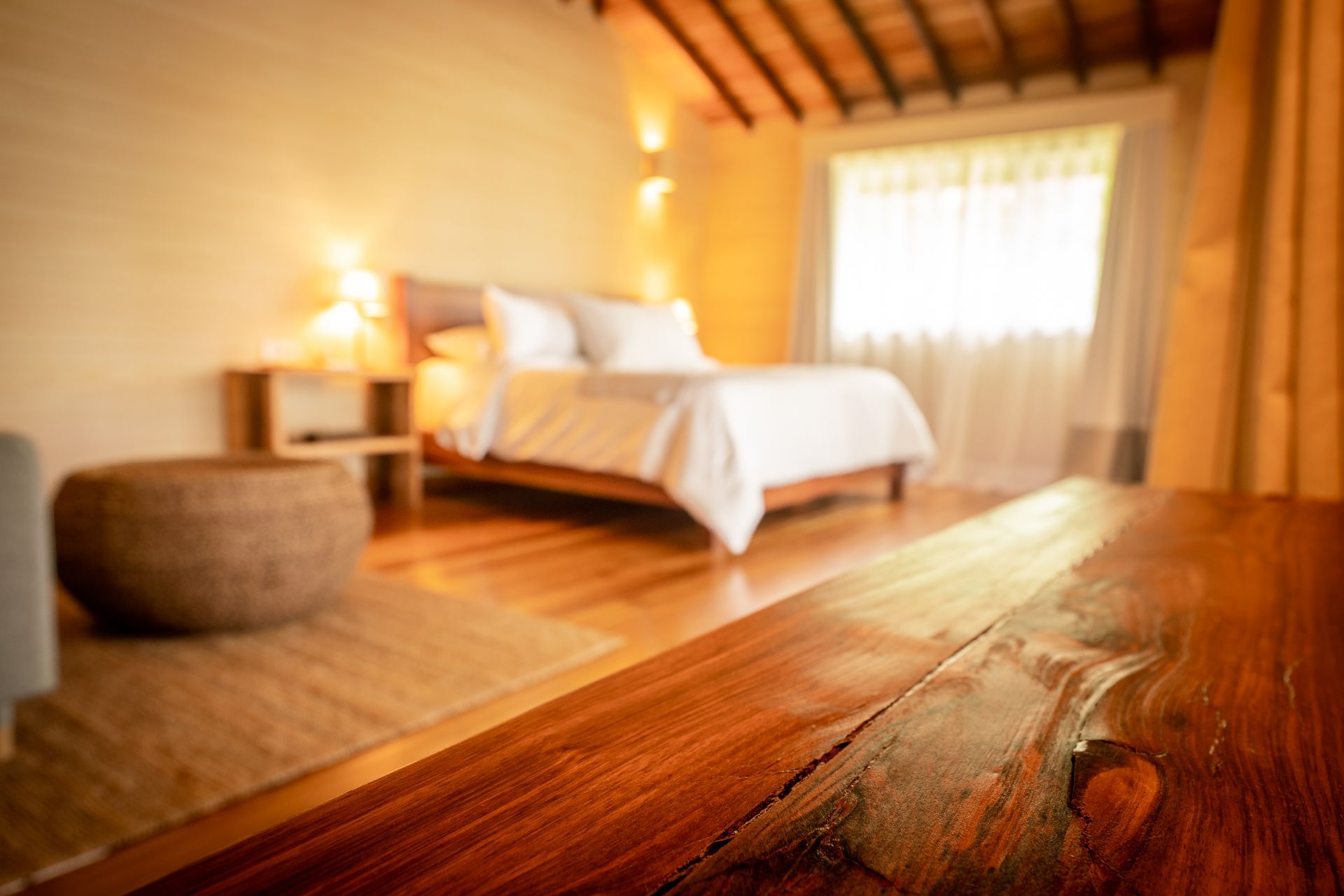 A hotel room with two beds and a wooden floor