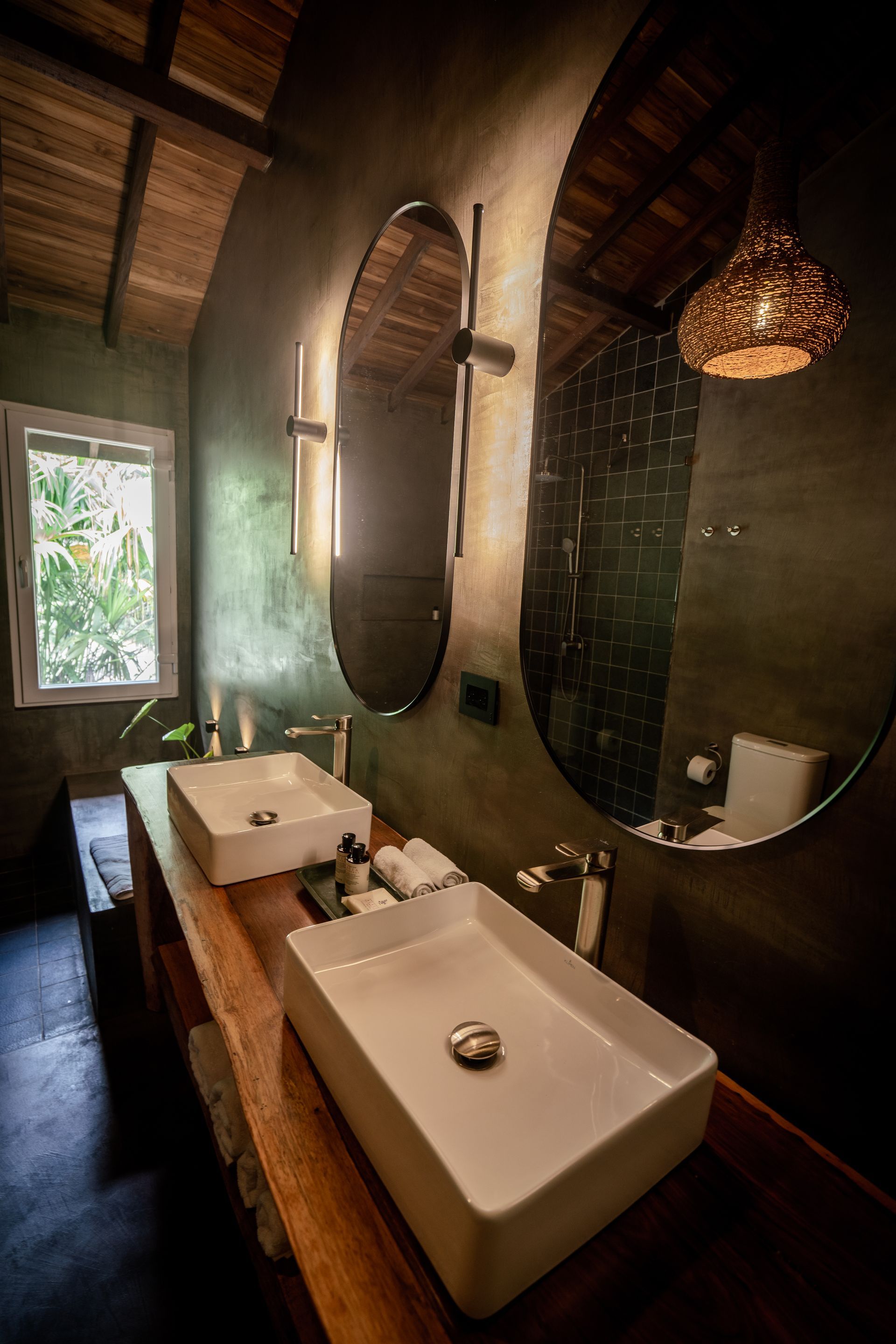 A hotel room with two beds and a wooden floor.