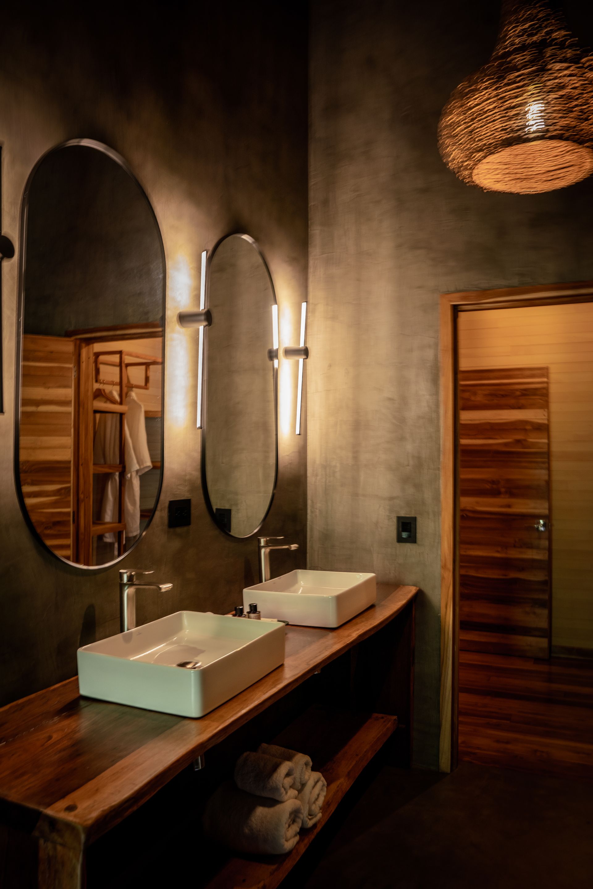 A hotel room with two beds and a wooden floor.