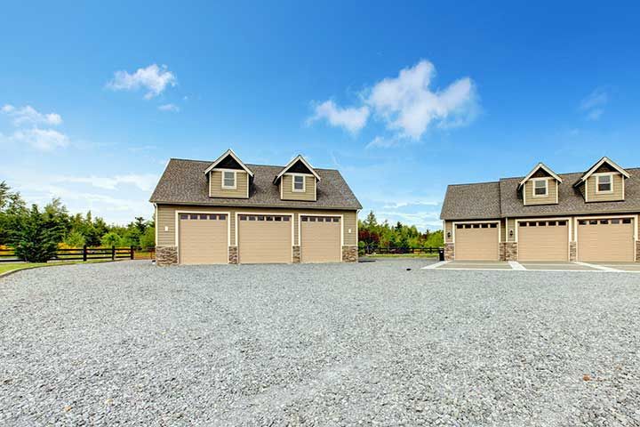 Large farm country house with gravel driveway 
