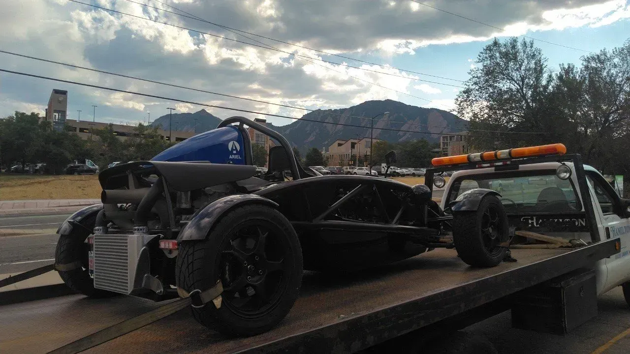 A motorcycle is being towed by a tow truck.