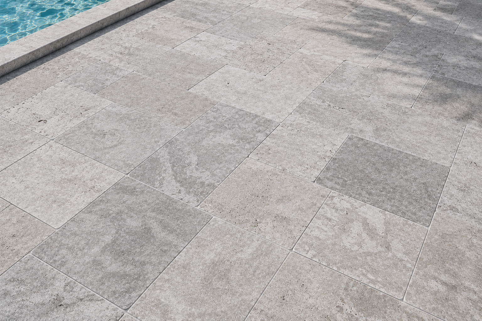 Gray stone pavement beside blue water