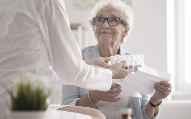 Older woman being given medicine