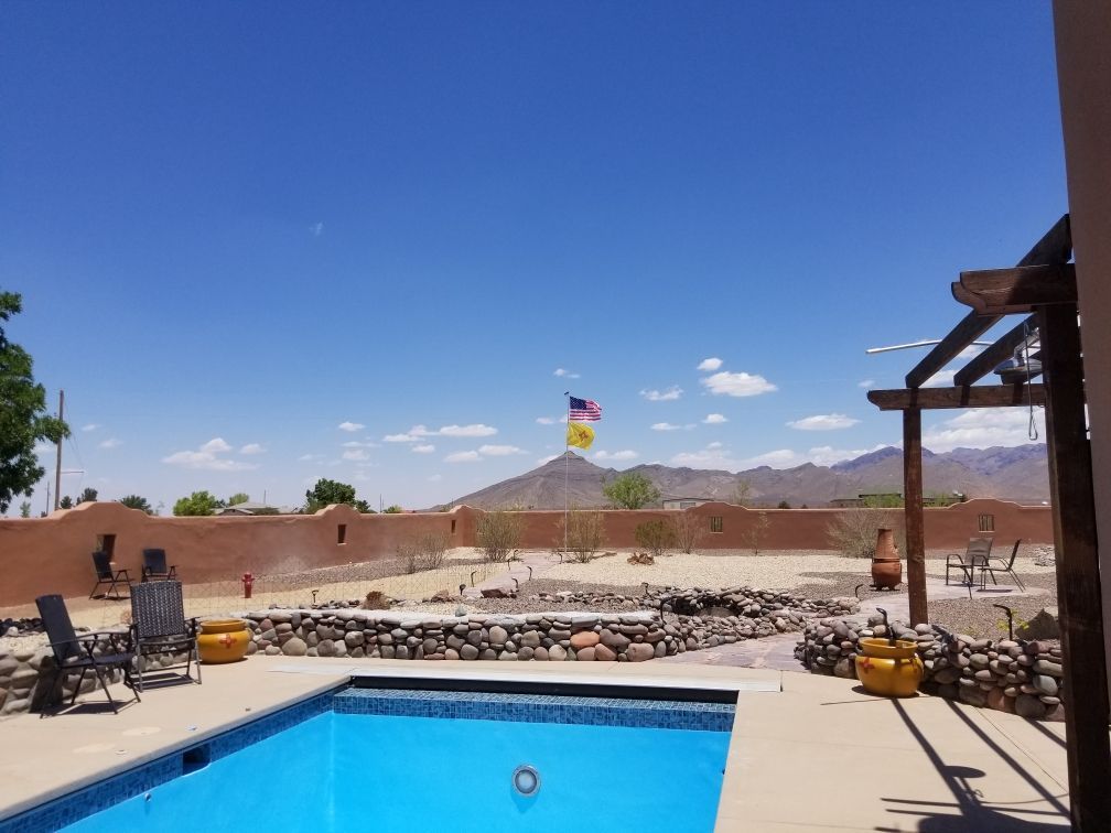 A large swimming pool with mountains in the background