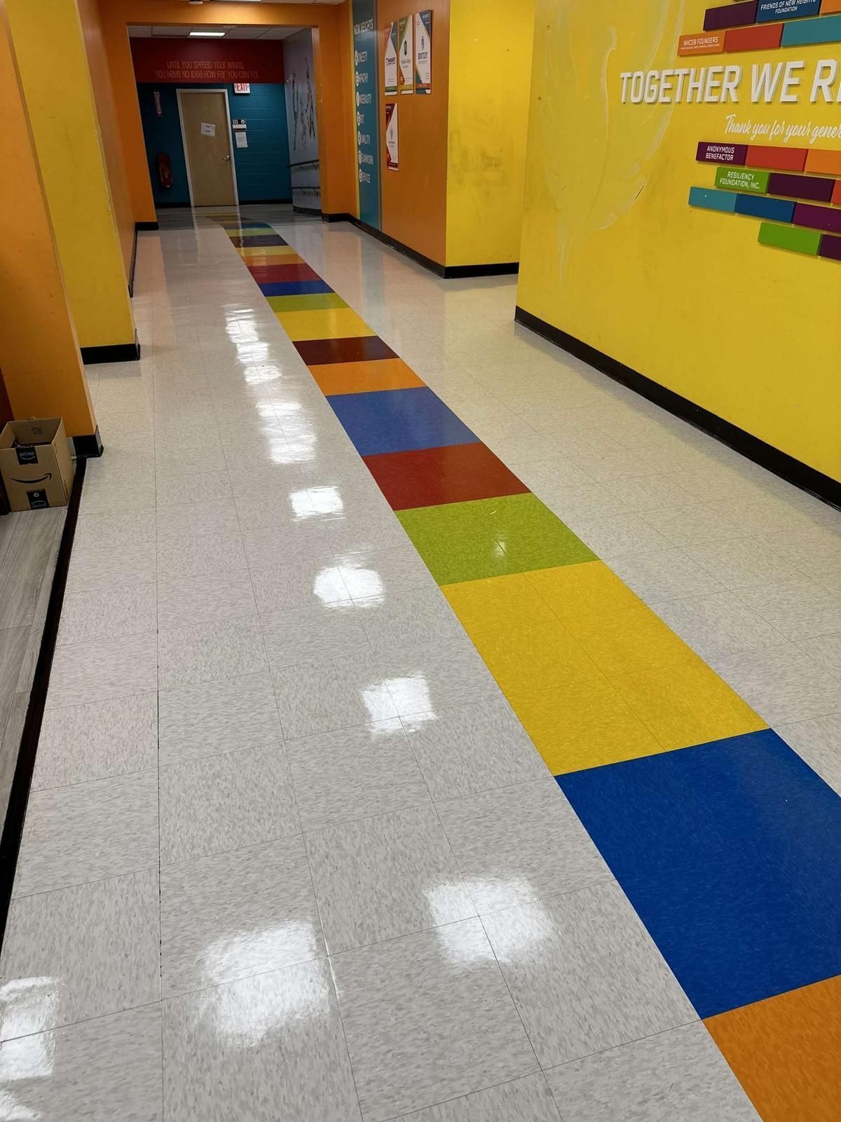A hallway with a rainbow colored tile floor